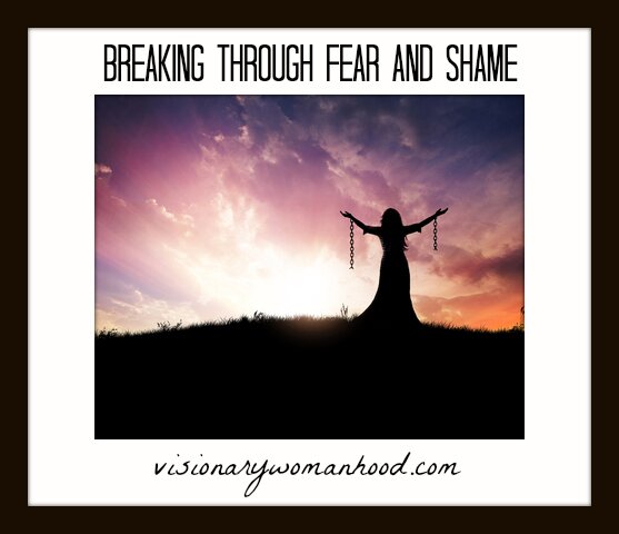 Woman standing with broken chains